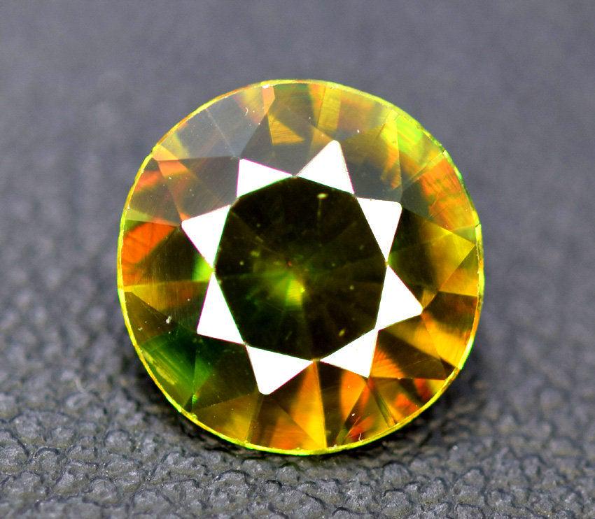 1.80 cts Natural Full Fire Chrome Sphene Titanite: Handmade Materials Sphene, titanite more Dimensions Carat weight: 1.80 Dimensions (mm) 9 x 9 x 4mm Weight (carats) 1.80 carats Full Fire Chrome Sphene Gemstone from Pakistan General Info: A brilliantl