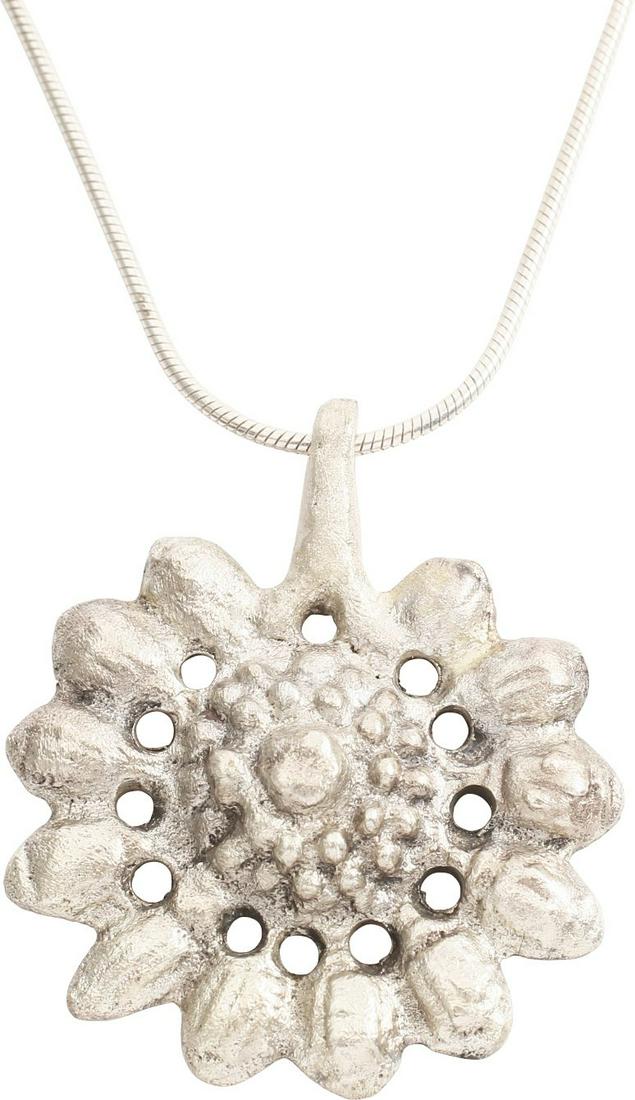 MEDIEVAL SILVER WOMAN’S PENDANT, 10th-12th CENTURY: Crusades period. Just over 1 1/4” height, silvered bronze. Comprising a radial splay of elongated hemispheres on stalks, probably a late reference to the Roman Rota Fortuna (Wheel of Fortune). That 