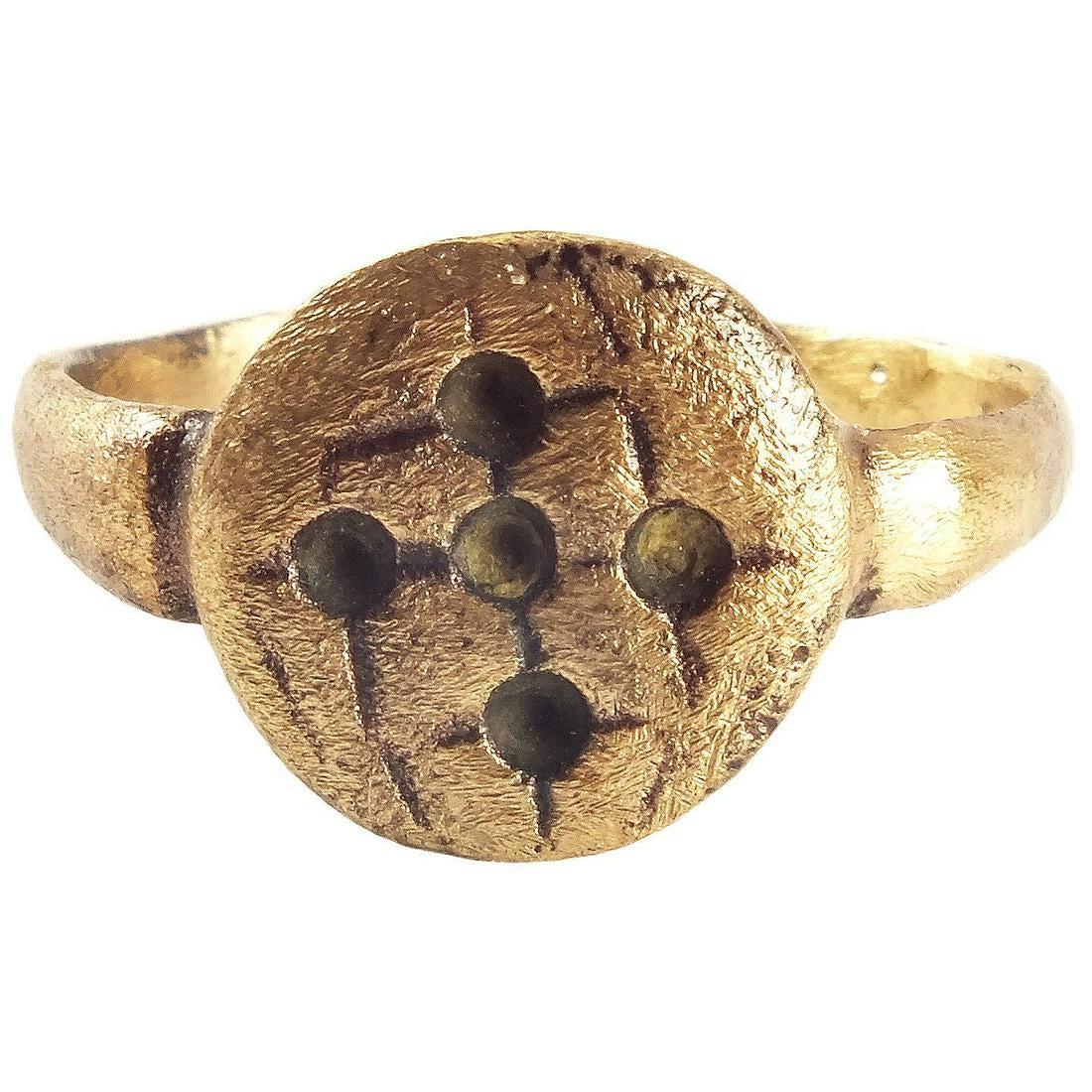 RARE BYZANTINE PILGRIM'S RING, C.500-700 AD: Classic early form with narrow, slightly tapered, band and circular bezel incised with five small circles representing the five wounds of Christ. Lightly textured from burial. Size 9. 18.9mm inner dia