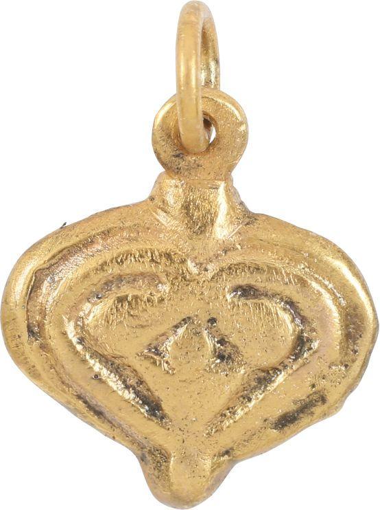 FINE VIKING HEART PENDANT 900-1050 AD: 5/8” width, domed with a broad double border and central trefoil motif. The inner borders scrolling to cross and form the cusp of the heart and the top of the trefoil. The foliate trefoil was a very