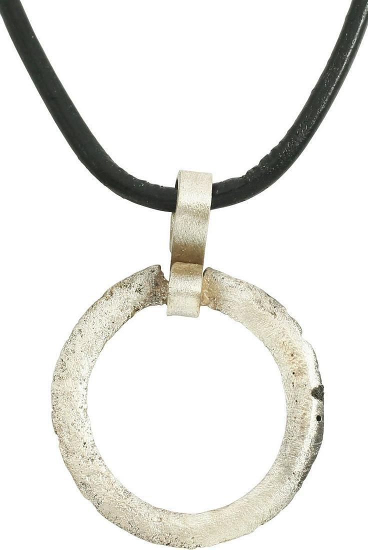 VIKING PROTECTIVE BROOCH C.870-1066. Cambridgeshire: Circular bronze, just under 1” diameter with rounded front and flat back. Surface lightly textured from burial. Worn in numbers on the surface of the jerkin, these small metal brooches provided a me