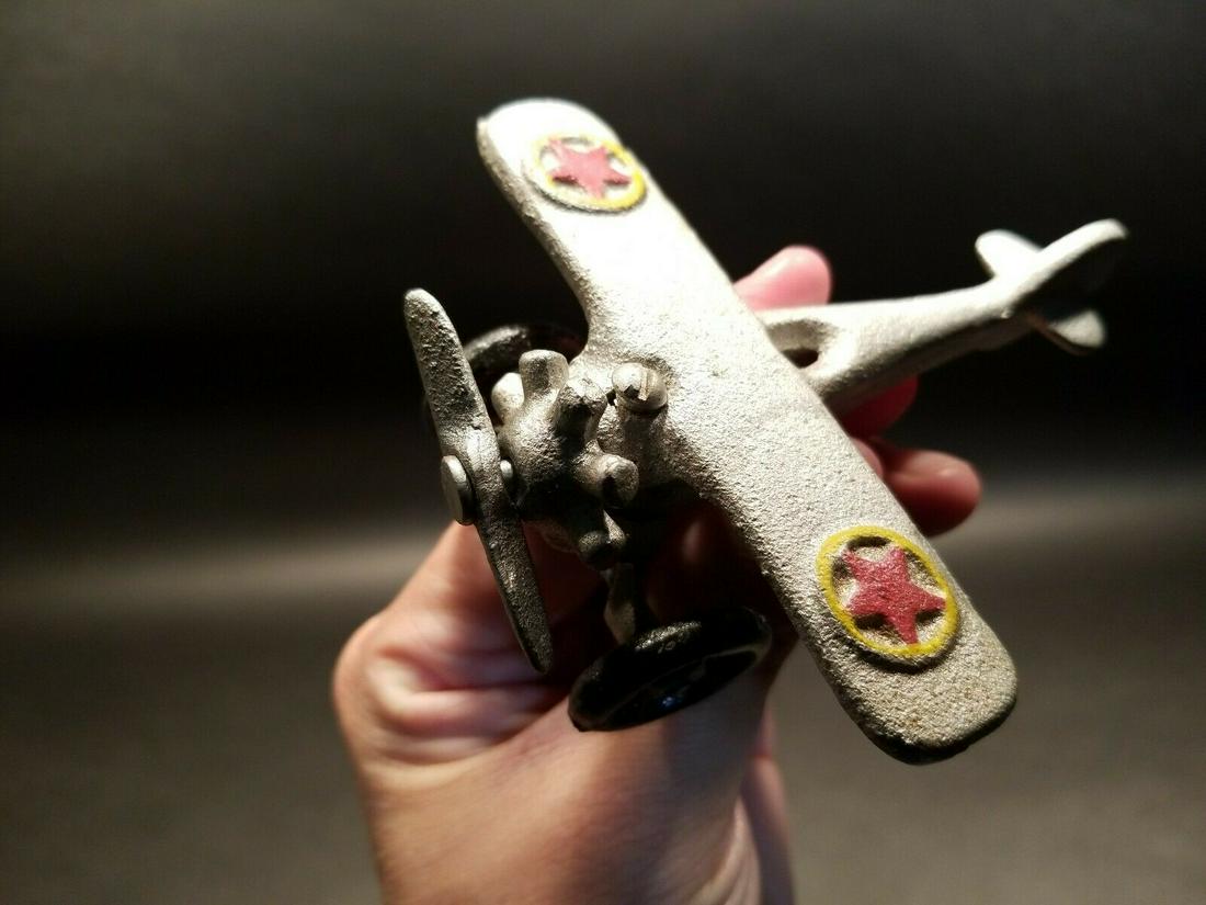 Cast Iron Airplane Toy: 4 5/8" long x 4" wide 2" Tall Great little reproduction cast iron airplane toy. All cast iron hand painted, slightly distress as shown in the images. Certainly looks old! Limited availability! Reserve