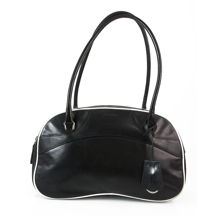 Prada Black Leather w. White Trimming Bowling Shoulder: A sport chic bag for a modern, active women, this is the bag for you !! This authentic Prada bowling style bag, is a finely crafted bag from black leather, has white leather trimming, double leather h