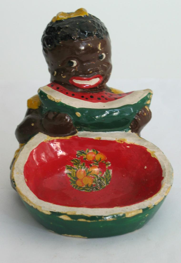 Vintage Figure Of Child Eating Watermelon.: Title: Vintage Figure Of Child Eating Watermelon. Date/Period: 1940's Dimension: 4” high Provenance:Plaster figure of a small black child eating watermelon. Shipping: Domestic: Flat-rate of $20.00 t