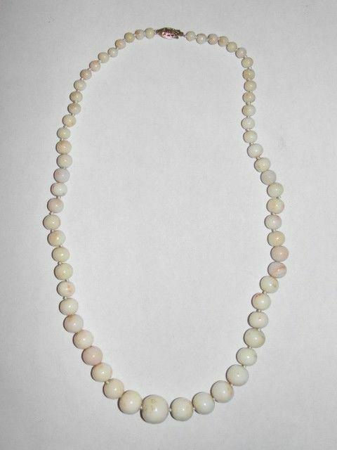Angel Skin Coral Graduated Bead Necklace: Gorgeous classic angel skin coral necklace... Lovely graduation and recently restrung on white silk, hand knotted to keep these lovely off white with light pink inclusion beads from wearing down. Circ
