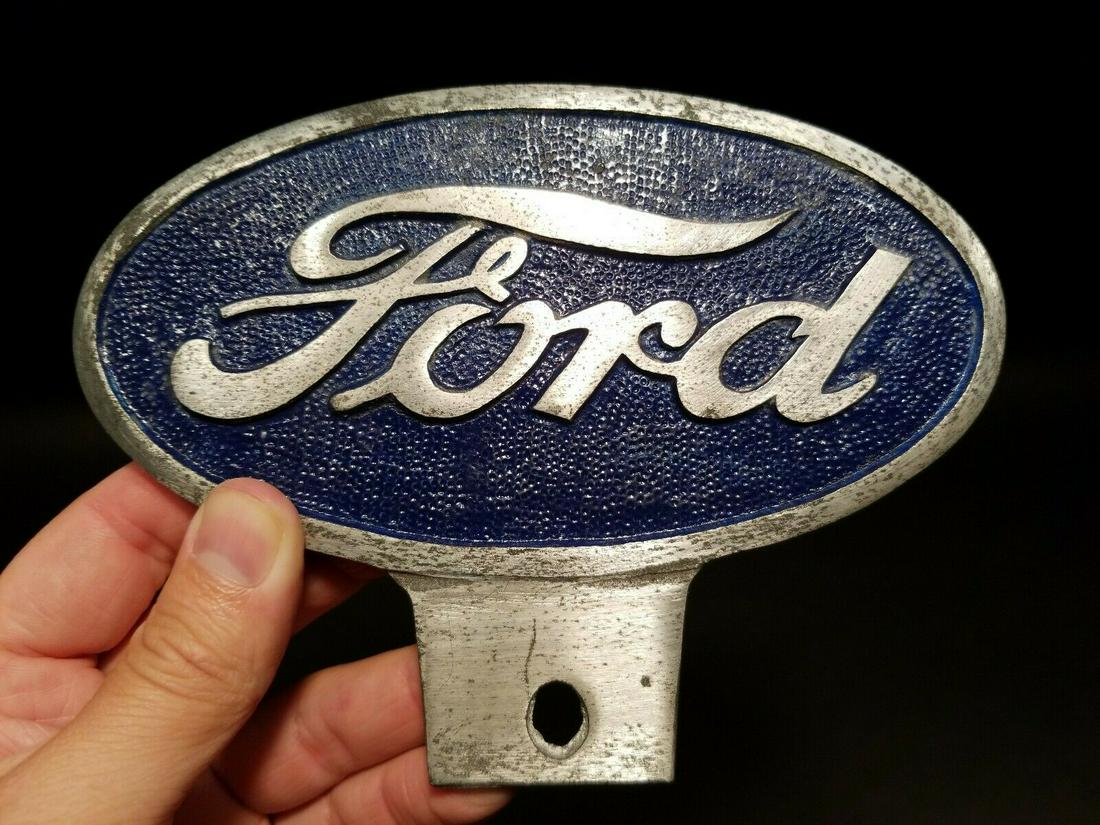 Aluminum Ford Car License Plate Fob Topper: 6 1/2" wide x 4 3/4" tall Wonderful reproduction Ford license plate topper. Good detail cast aluminum hand painted and slightly aged to look like an antique. Certainly hard to tell its age. Reserve: $