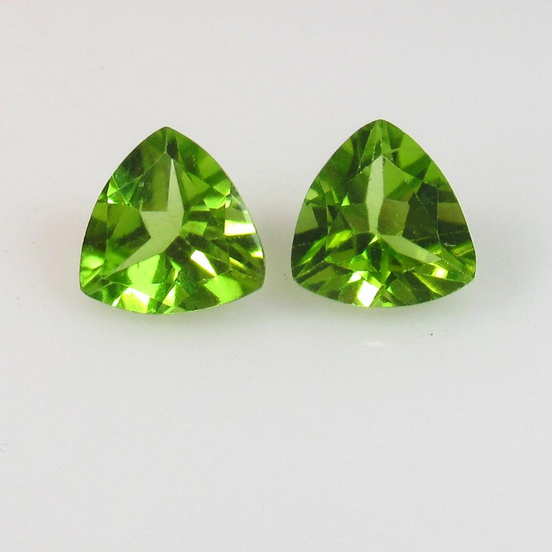 2.39 Ct Genuine Pakistan Peridot Trillion Pair: No Reserve! Title: 2.39 Ct Genuine Pakistan Peridot Trillion Pair Stone Clarity: VVS Gemstones: Natural Peridot Carat Weights: 2.39 Size/Dimensions: 7.10 x 7.00 x 3.90 mm / 2 PC's Additional Informati