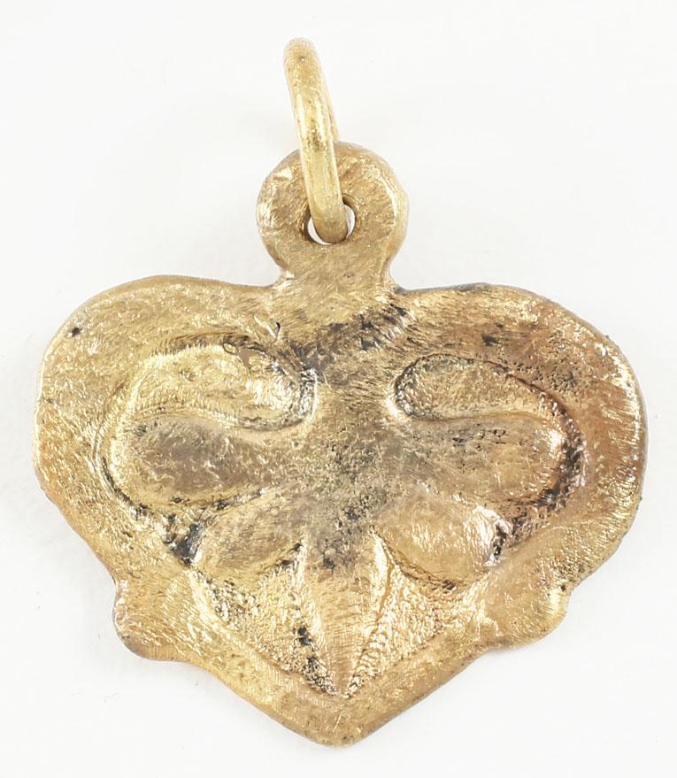 VIKING HEART PENDANT 900-1050 AD.: ¾” width of flat form, made bu the open face mold method. Broad border with a central pentafoil motif. The form of the heart is natural as in the body rather than stylized with the top cusp. Both f