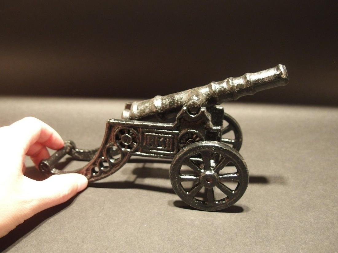 Cast Iron Art Deco RMI Cannon Toy: 8 1/2" Long 4 3/8" Tall 3 1/2" Wide Great little reproduction cast iron cast iron cannon. All cast iron painted black. The black paint is slightly distressed in places. Looks as if it is 30 years old.