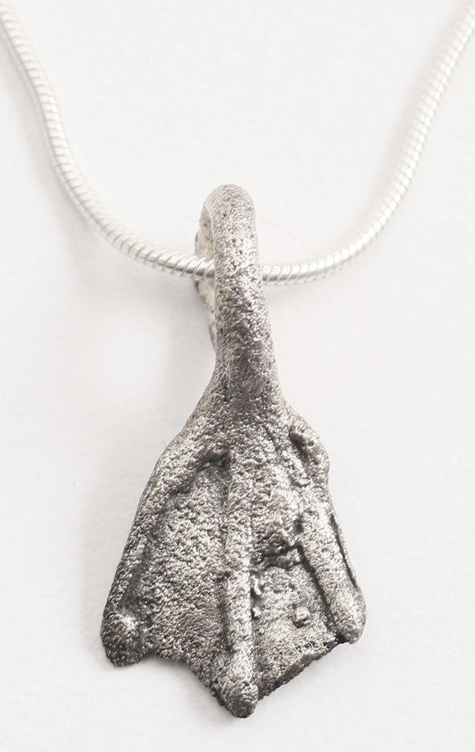 VIKING SORCERER'S AMULET.: 10th-11th century AD. Over 7/8” height. Bronze shaped as a duck’s foot and intricately detailed. A burial at Viden, Denmark contained the body of a woman of wealth and status buried with henbane s
