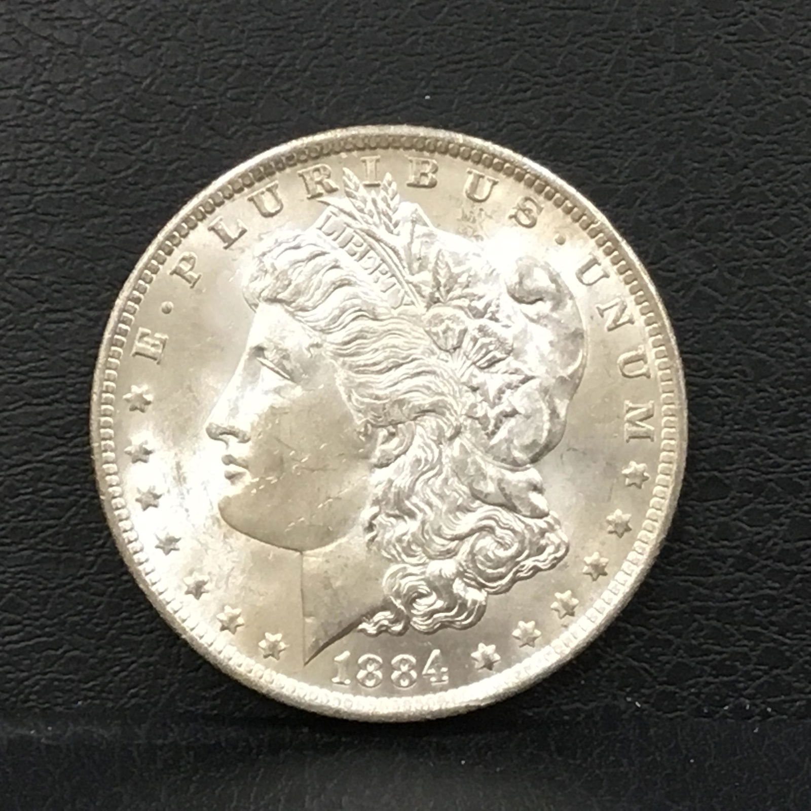 1884-O Morgan Silver Dollar: Title: 1884-O Morgan Silver Dollar Description: Morgan Silver Dollar Date/Period: 1884-0 Material: 90% Silver Dimension: 38.1mm Additional Info:RAW Condition: AU58 Reserve: $32.00 Shipping: Domesti