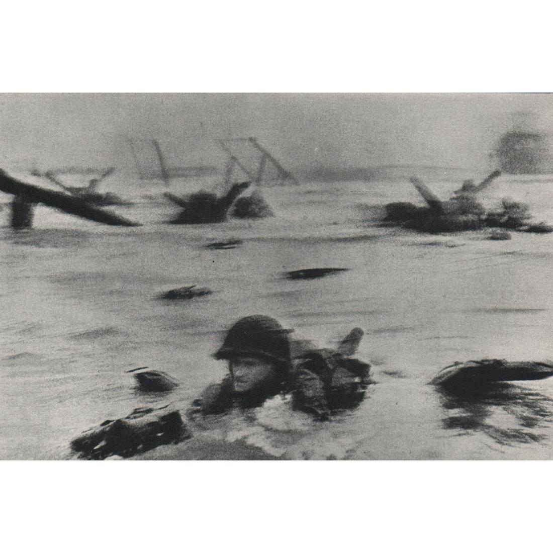 ROBERT CAPA - D-Day, Omaha Beach: Artist: ROBERT CAPA Print Title: D-Day, Omaha Beach, June 6, 1944 Medium: Sheet-fed Gravure Printing Date: 1960's Printed in Holland Image Size approx: 4.5 x 7 inches Robert Capa (1913-1954) was a Hun