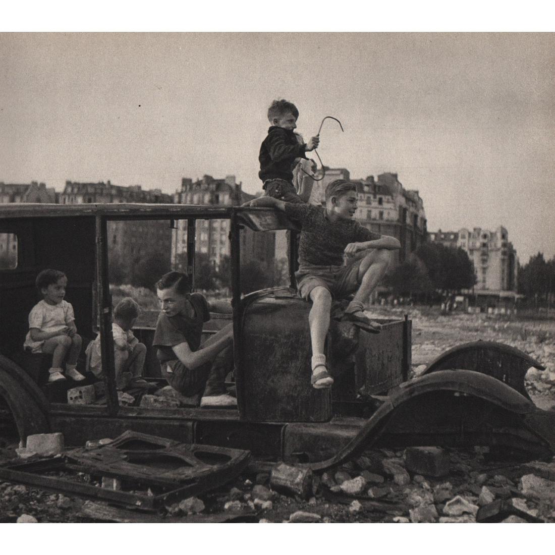 ROBERT DOISNEAU - Kids play near Porte d'Orleans: Artist: ROBERT DOISNEAU Print Title: Kids play near Porte d'Orleans Medium: Sheet-fed Gravure Printing Date: 1940's Printed in Switzerland Image Size approx: 6 x 6.75 inches Robert Doisneau (1912-1994