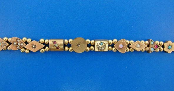WOW Victorian 14k Yellow Gold & Gemstone Slide Bracelet: DK 14k Yellow Gold & Gemstone Slide Bracelet Victorian Circa 1900s · The weight is 11.7 grams. · The length is 6 7/8 inches. The height is 3/8 of an inch. The width is ¼ of an inch. There are