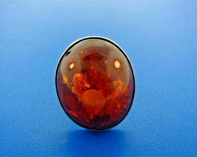 STATEMENT Sterling & Amber Ring: DK Sterling & Amber Ring · This is a must for any collector. · The weight is 12.3 grams. · The height is 1 3/16 inches. The length is 1 inch. The width is ½ of an inch. The ring size is 7. 