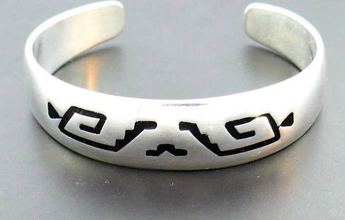 Sterling Silver Enamel Mexican Ornamented Bangle: NS J00 Mexican bangle made of sterling silver features ethnic enamel ornament Stamped with a maker's mark, a hallmark for sterling silver and a country of origin (Mexico) Measurements: 5/8" H x 6"