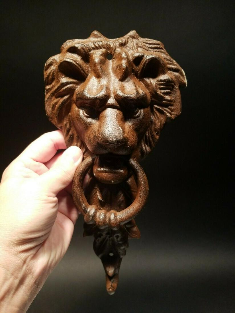Cast Iron Lion Door Knocker w Hook: 10 3/4" Tall x 5 1/4" wide 2 lbs 7oz Nice heavy quality reproduction cast iron door knocker! As you can see this is a solid lion face door knocker. The ring in the lions mouth serves as the knocker. N
