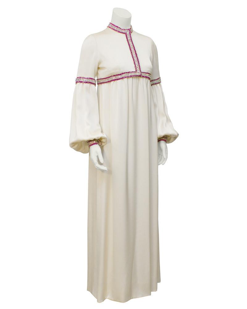 Guy Laroche Cream Haute Couture Gown with Pink and: Amazing 1970s Guy Laroche couture cream silk gown. Mock turtleneck, billowing sleeves and empire waist. Beautiful pink, gold, white and silver sequins and beading at elbows, neckline, empire waist and
