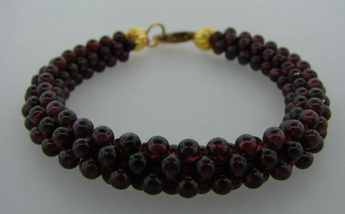 CHIC Vintage Woven Garnet Bracelet: DK Vintage Woven Garnet Bracelet · Wonderful bracelet that is a necessity in your collection. · The weight is 16.5 grams. · The length is 7 inches. The width is 3/8 of an inch. · This is in