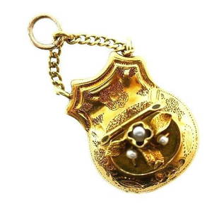 VICTORIAN 14k Yellow Gold & Pearl Mechanical Coin Purse: DK Victorian 14k Yellow Gold & Pearl Mechanical Coin Purse Charm Circa 1900s · This is a must for a collector. The weight is 3.7 grams. The length with bail is 1 1/4 inches. The width is 3/8 of an