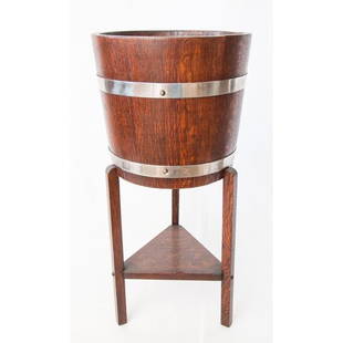 Antique English Oak Wine Cooler or Jardiniere: A superb early 20th-Century English oak wine cooler or jardiniere on a tripod base with a shelf. Maker's mark on interior. This fine quality piece is sturdy and well made with a sleek design, perfect