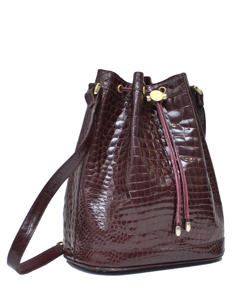 Anonymous Burgundy Crocodile Bucket Bag: Amazing authentic burgundy Crocodile skin drawstring bucket bag from the mid 1970s. The long strap allows the bag to be carried on the shoulder or across body and the gold hardware compliments the dee