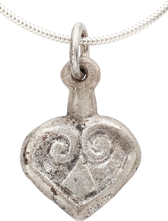 VIKING HEART PENDANT 10th-11th CENTURY AD: Good example of the fully evolved form with cusped top and broad rounded sides which scroll at the top to form the upper members of a trefoil. Slightly domed section. Just under 3/4Â” height. The h
