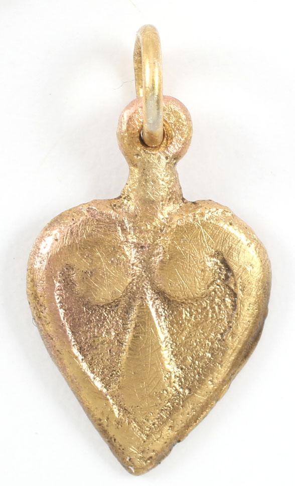 VIKING HEART PENDANT 900-1050 AD: Just under 7/8Â” height, made by the open face mold method with broad borders terminating as a central trefoil motif and forming the cusped heart top. The foliate trefoil was a very popular motif f
