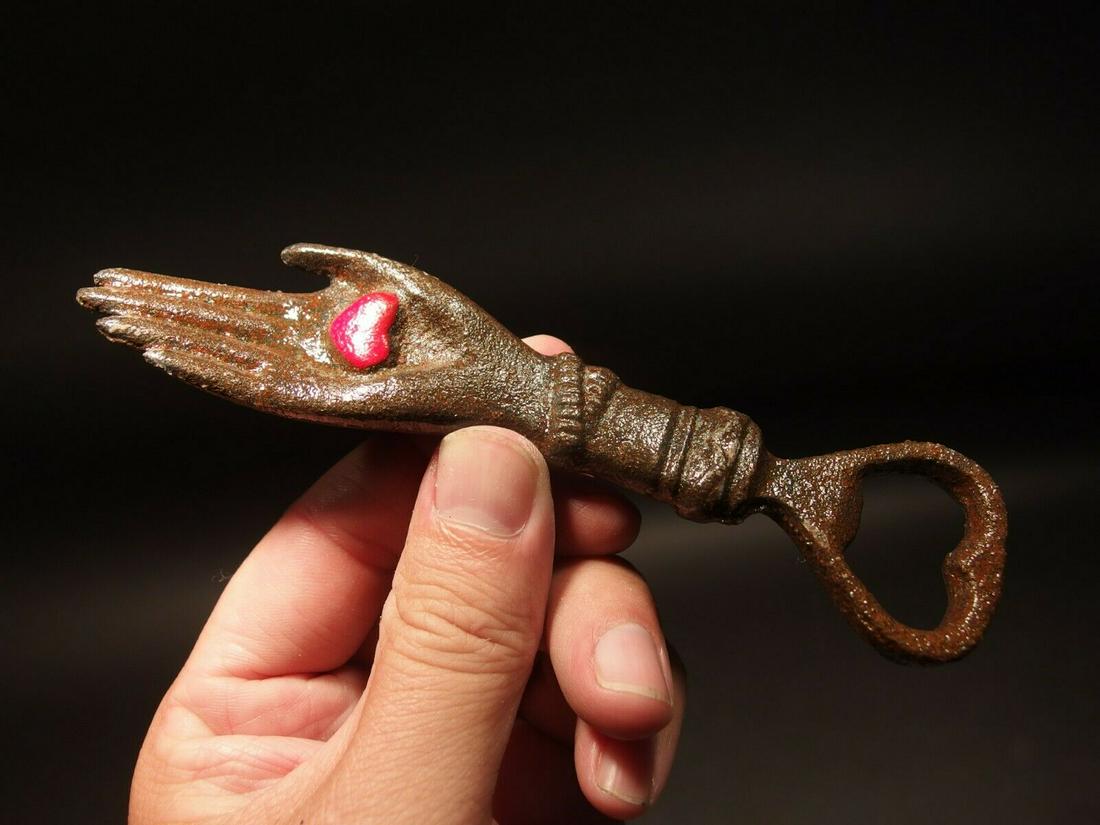 Cast Iron Heart in Hand Odd Fellows Bottle Opener: 5 3/4" Long x 1 1/4" Wide A wonderful reproduction cast iron heart in palm bottle opener. Many times the symbol of a heart in an open palm is symbolic of an open welcome or charity. It has also been t