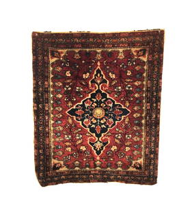 Antique Persian Sarouk Small Rug 2'0 x 2'4: This antique Persian Sarouk Pushti (small rug) was woven in the early 20th Century. The design features a dark blue center medallion with large mirroring end finials all atop a field of flowers and