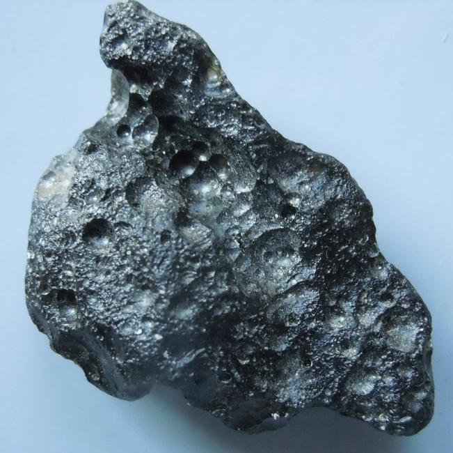 PHILIPPINITE TEKTITE - FROM METEORITE IMPACT: Title: PHILIPPINITE TEKTITE - FROM METEORITE IMPACT Origin: Paracale, Camarines Norte, Luzon, Philippines Size: 3x2x1 cm / 7 gram Additional Information: deeply ornamented and very glossy rizalite/phi