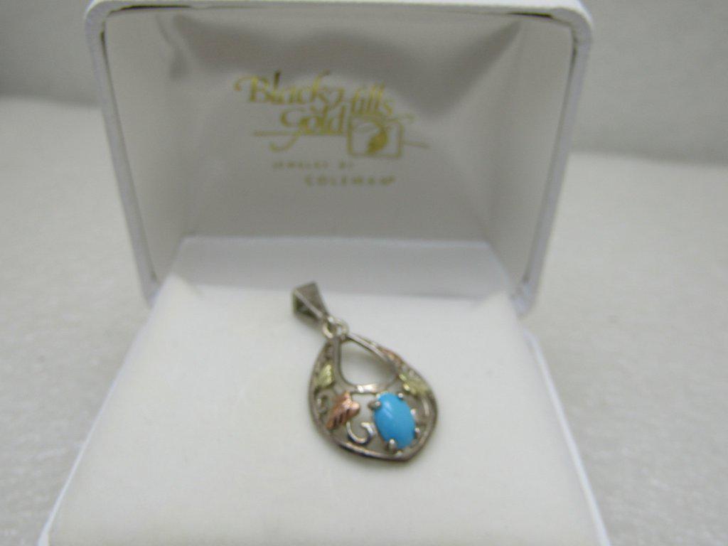Vintage Sterling 12kt Black Hills Gold Turquoise: Vintage Sterling 12kt Black Hills Gold Turquoise Pendant, Black Hills Gold by Coleman in original box Box. The pendant has a Sleeping Beauty oval cabochon that is appx. 6mm by 4.5mm, It has a leaf and