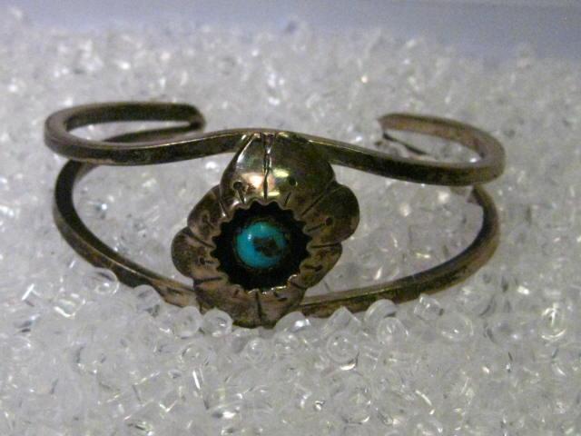 Sterling Silver Southwestern Shadow Box Turquoise Cuff: Vintage Sterling Silver Turquoise Shadow Box Turquoise Cuff Bracelet with a floral or volcano-like theme. It is signed MMM. Weight is 26.02 grams. The inside measurement is 5" with a 1" opening. The o