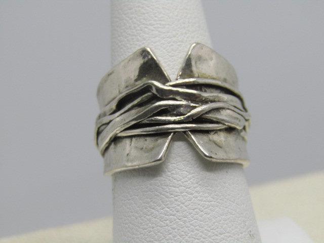 Wide Sterling Silver Statement Ring, Wrapped Design.: Wide Sterling Silver Statement Ring, wrapped design with what looks like strands that are intertwined. The ring has a cut-out V front and back and is slightly bowled in the center like a small valley 