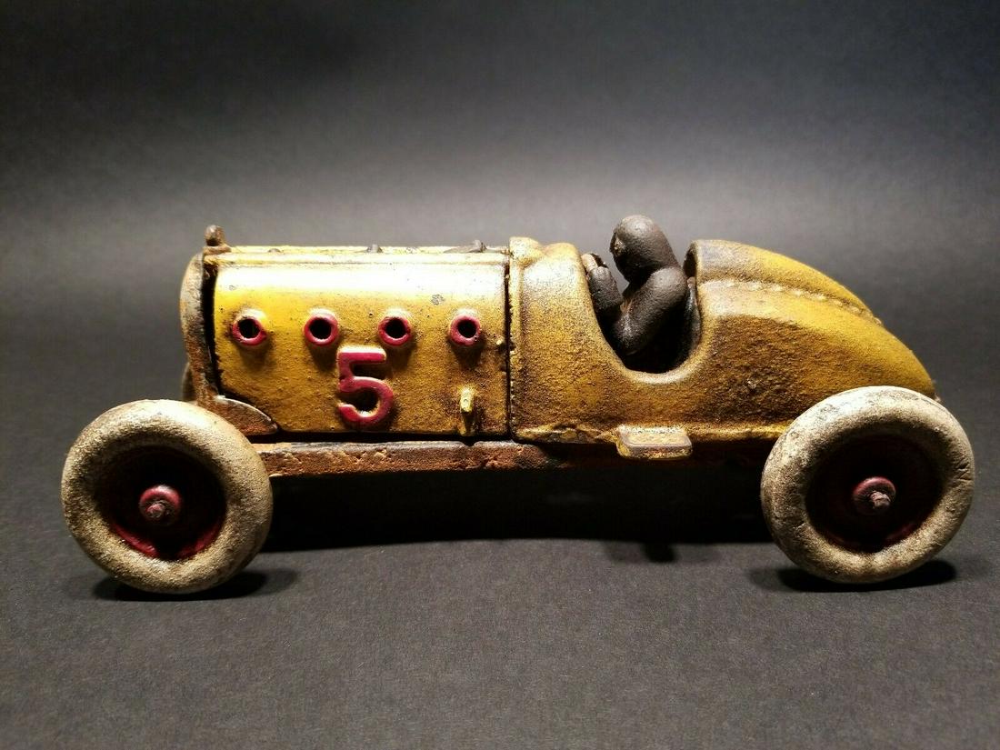Cast Iron #5 Toy Race Car w Lifting Hood: 9" Long x 3 1/2" Wide 3 3/4" Tall 2 lbs 13 oz Such a neat reproduction cast iron car! As you can see this heavy cast iron car was wonderfully hand painted and distressed to look original. The car is m