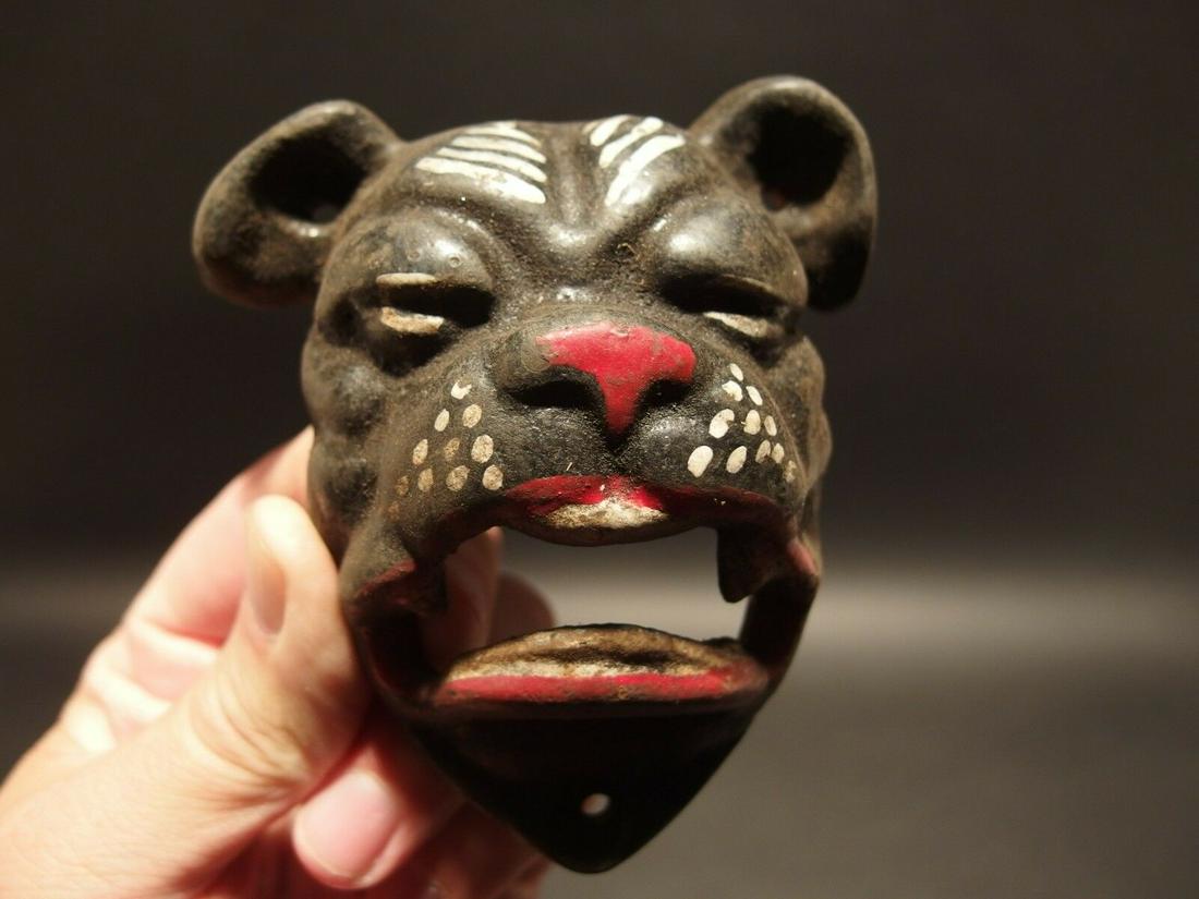 Cast Iron wall mount folk art Bulldog Beer Bottle: 4" Tall x 3 1/2" Wide Such a neat reproduction antique cast iron bulldog wall mounted bottle cap opener. The mouth of the bulldog is where you would open the bottle. Certainly a great accent piece! Be