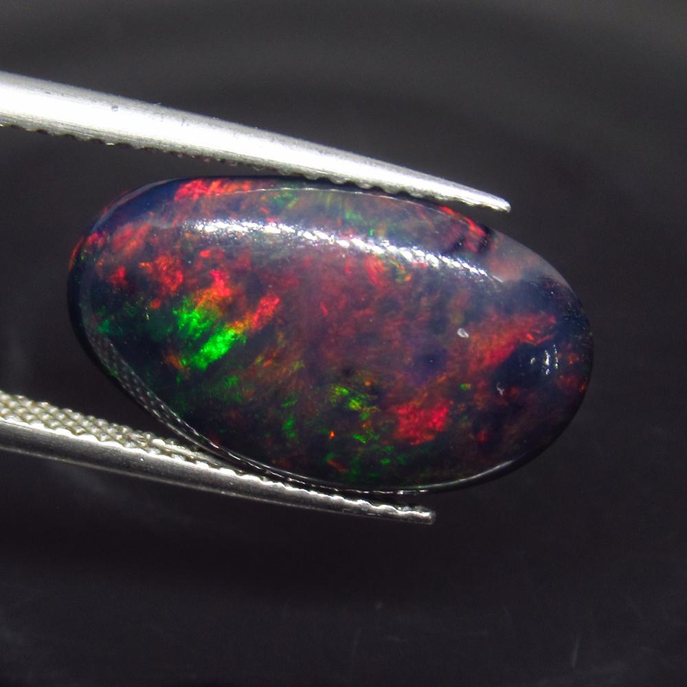 5.74 Ct Geuine Ethiopian Fire Black Opal Oval Cab: No Reserve! Title: 5.74 Ct Geuine Ethiopian Fire Black Opal Oval Cab Stone Clarity: Translucent Gemstone: Natural Black Opal Carat Weights: 5.74 Size/Dimensions: 17.80 x 10.40 x 6.20 mm Excellent Oval