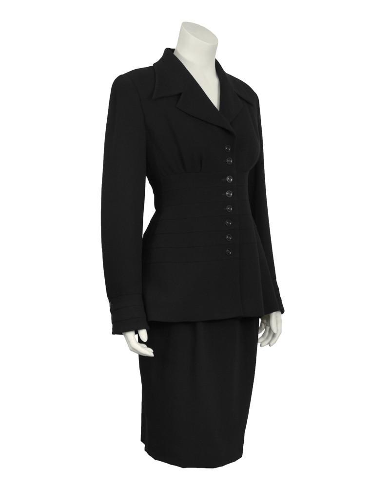 Karl Lagerfeld Black Wool Panelled Suit: Karl Lagerfeld black wool suit from the 1980's. The feminine style jacket features slight gathering at bust and a multiple band detail along the waist creating a flattering silhouette. Black buttons d