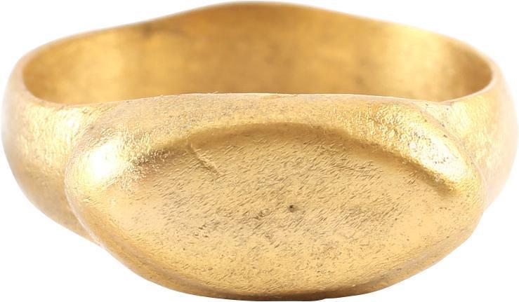 VIKING MAN’S RING 10TH-11TH CENTURY AD SZ 9: Size 9, slightly oval form. A broad band with a rounded face expanding toward the bezel. The shoulder with hash marks and raised oval stepped bezel with remnants of a cipher (?). Lightly textured from