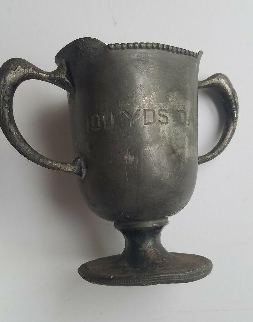 Trophy loving cup 100 yard dash 1917: Great looking piece in fair condition . 50 Yard dash. Approximately 5" tall' Shipping includes insurance. Shipping: Domestic: Flat-rate of $12.00 to anywhere within the contiguous U.S. International: 