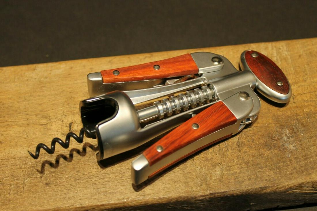 Laguiole Corkscrew with wood Handles: 7 1/2" Tall 3" Wide Nice quality heavy wing style Laguiole corkscrew! The heavy weight corkscrew (15.2 oz.) has wood inlaid handles. Open spiral with non-stick black surface on spiral. Reserve: $30.00