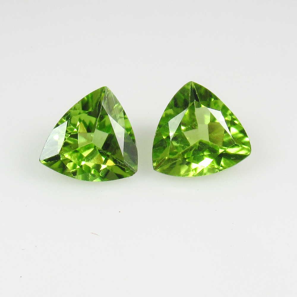 2.29 Ct Natural Pakistan Peridot Trillion Pair: No Reserve! Title: 2.29 Ct Natural Pakistan Peridot Trillion Pair Stone Clarity: VVS Gemstones: Natural Peridot Carat Weights: 2.29 Size/Dimensions: 7.20 x 7.10 x 4.10 mm / 2 PC's Additional Informati