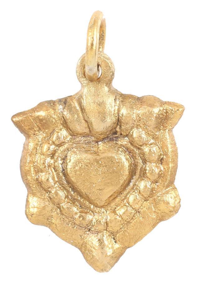 FINE VIKING HEART PENDANT 900-1050 AD: Over 3/4” height, with nubs at the sixth points. Domed form. Central cusped heart with a beaded border and broad edge. The form of the heart is natural as in the body rather than stylized with the t