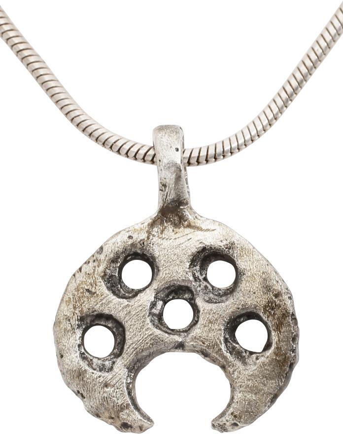VIKING LUNAR NECKLACE PENDANT C.870-1050 AD JEWELRY: Cambridgeshire, England. Just over 1/2” width of broad crescent form- pierced with five circles. The crescent represents the moon and the circles probably represent specific stars on which Vikings r