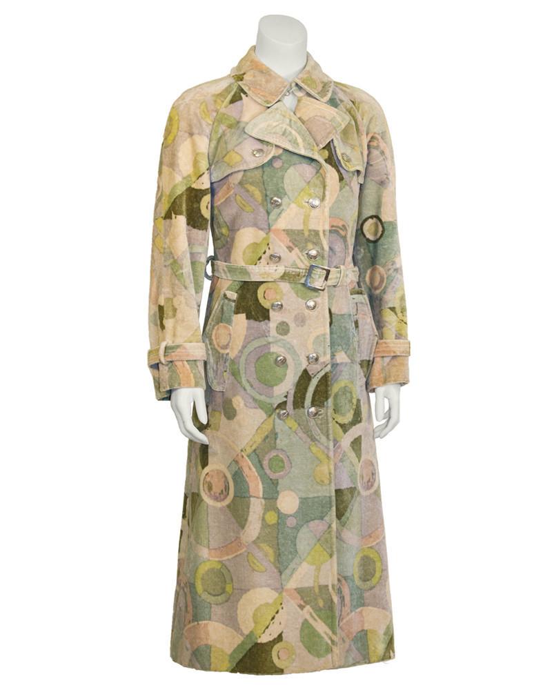 Ken Scott Green Abstract Print Velvet Trench: Fabulous 1970's green velvet trench coat featuring an abstract pattern with notes of cream, blue, turquoise and rose. Slightly flared, double breasted coat with storm flaps, two flap pockets, a waist 