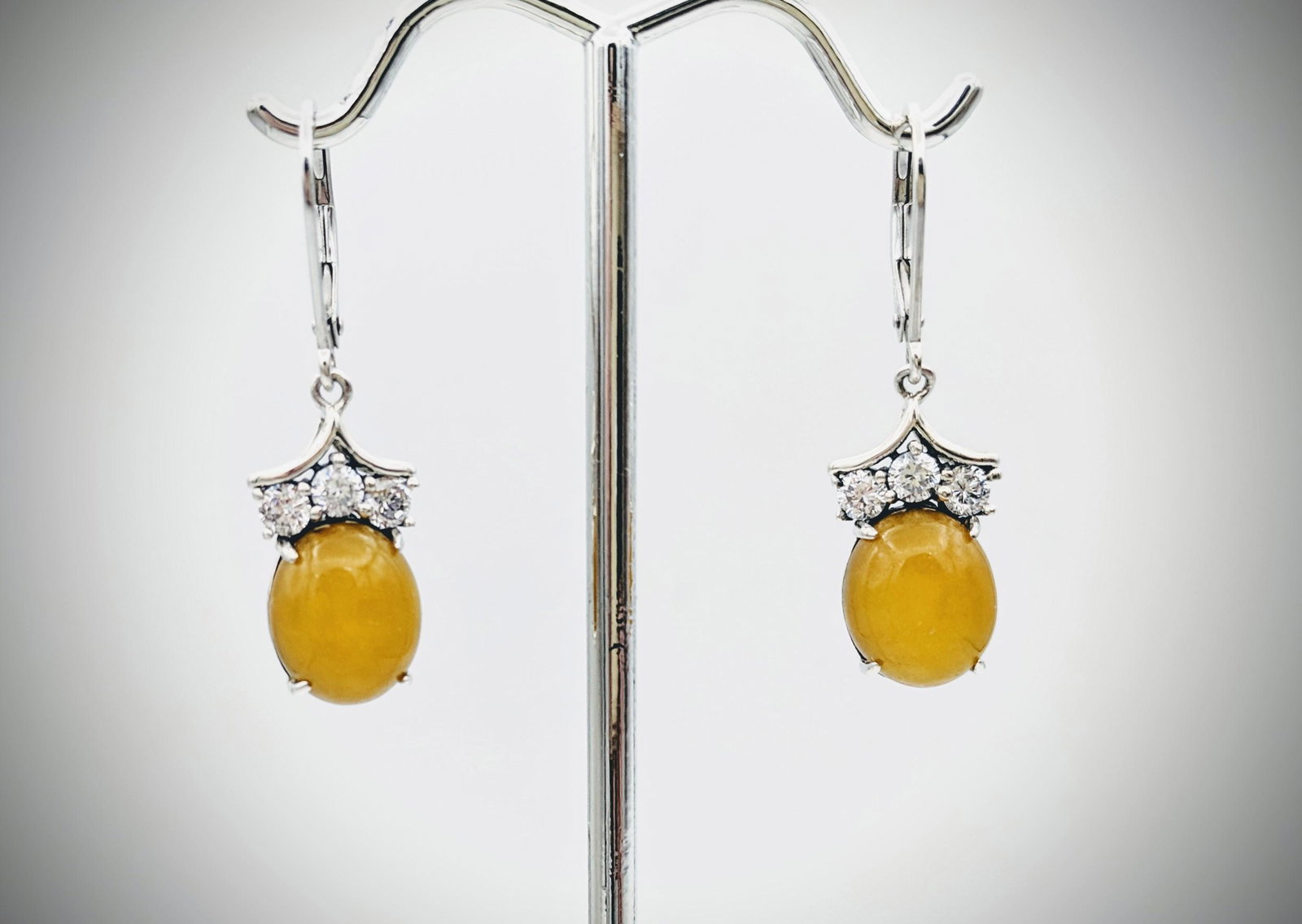 Sterling Silver Yellow Jadeite & CZ Earrings: Title: Sterling Silver Yellow Jadeite & CZ Earrings Brand: Jean Lin Collection Metal Purity: 925 Sterling Silver Gemstones: Yellow Jadeite & Cubic Zirconia Carat Weights: Each Earring has 1 Oval Yello