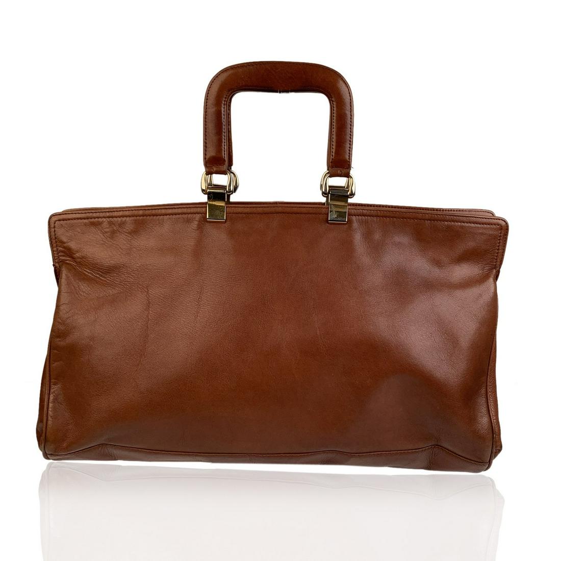 Bottega Veneta Vintage Tan Leather Tote Bag Handbag: Vintage BOTTEGA VENETA east-west bag crafted in smooth tan leather. The bag features double top handles, upper zipper closure and satin lining in brown color. 1 side zip pocket inside. 'BOTTEGA VENETA