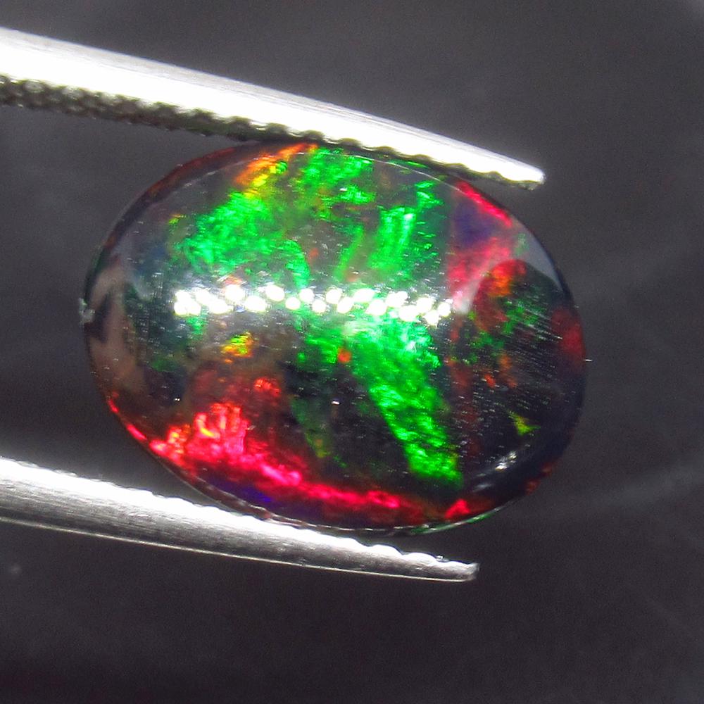2.57 Ct Natural Ethiopian Fire Black Opal Oval Cab: No Reserve! Title: 2.57 Ct Natural Ethiopian Fire Black Opal Oval Cab Stone Clarity: Translucent Gemstone: Natural Black Opal Carat Weights: 2.57 Size/Dimensions: 11.80 x 9.00 x 5.50 mm Excellent Oval