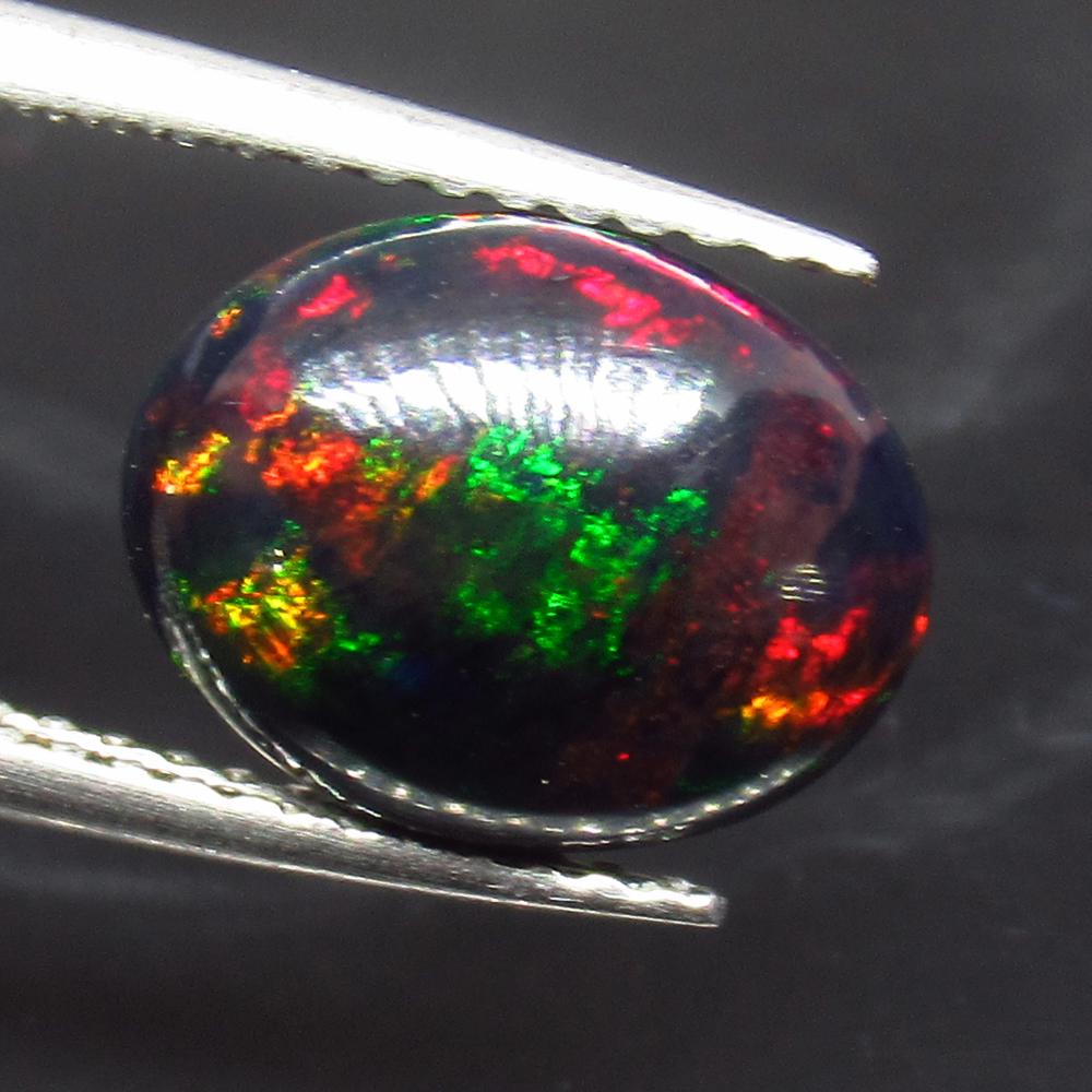 1.68 Ct Natural Ethiopian Fire Black Opal Oval Cab: No Reserve! Title: 1.68 Ct Natural Ethiopian Fire Black Opal Oval Cab Stone Clarity: Translucent Gemstone: Natural Black Opal Carat Weights: 1.68 Size/Dimensions: 10.60 x 8.40 x 4.10 mm Excellent Oval