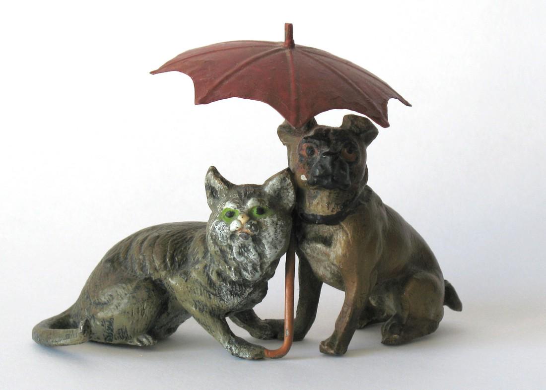 Vintage Spelter Cat & Dog Under Umbrella.: Title: Vintage Spelter Cat & Dog Under Umbrella. Date/Period: 1930's Dimension: 4” x 3” Description:Very nice metal sculpture of a cat & dog under a red umbrella. All original paint & condition. A